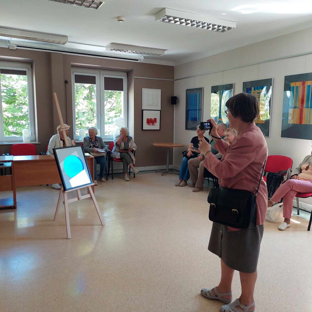 Przestrzen-dzwiek-kolory-2 Starsza kobieta fotografuje pracę plastyczną